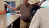 Thumbnail for Texas parent manhandled by cop from school board meeting where he was protesting child grooming pornography in the classroom.