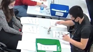 Thumbnail for Man inside polling area has been filling out BLANK BALLOTS for over an hour, and stamping them, with a uniformed officer standing right there.